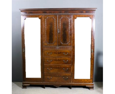 A mahogany wardrobe in the manner of Maple & Co, the moulded cornice with "Greek Key" ornament to frieze, fitted central cupb