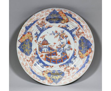 A Chinese "Imari" porcelain dish painted in blue, orange, red and gilt with a pavilion in a garden surrounded by Chinese lant