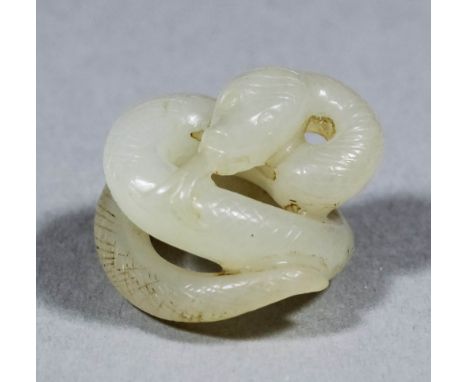 A small Chinese white jade carving of a coiled snake, 71mm diameter x 16mm high 