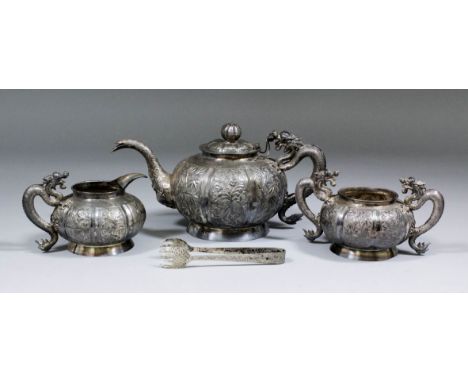 A Chinese silvery metal spherical three piece tea service, the panelled bodies embossed with bamboo shoots, blossoms and leaf