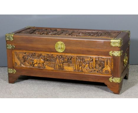 A Chinese teak and camphor wood lined blanket chest by George Zee & Co, Kowloon, Hong Kong, the panels carved with officials 