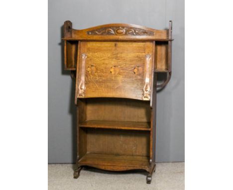 An early 20th Century oak bureau in the Arts & Crafts style, the slope inlaid with three circular panels and with oxidised st