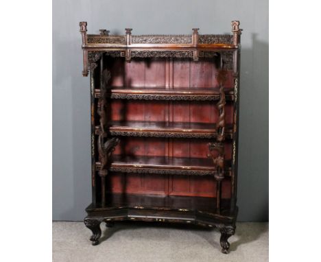 A Chinese hardwood open front bookcase inlaid with scroll and floral ornament, the angled and overhanging cornice fretted and