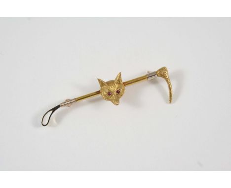 HUNTING INTEREST: a 9ct. gold fox mask and riding crop brooch, realistically formed, with ruby eyes, 6cm. long.