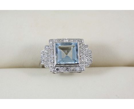 AN AQUAMARINE AND DIAMOND CLUSTER RING the square-shaped aquamarine is set within a surround of circular-cut diamonds, with f