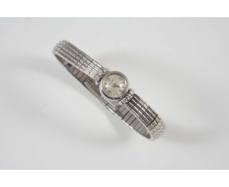 A LADY'S 18CT. WHITE GOLD AND DIAMOND WRISTWATCH BY JAEGER-LeCOULTRE the signed circular dial with Arabic quarters and dagger
