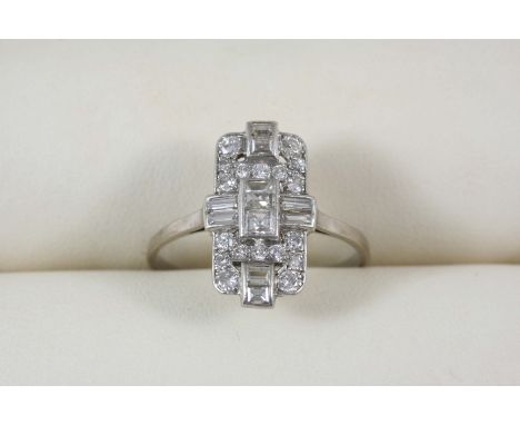 AN ART DECO DIAMOND PLAQUE RING centred with two square-shaped diamonds within a surround of baguette-cut diamonds and milleg