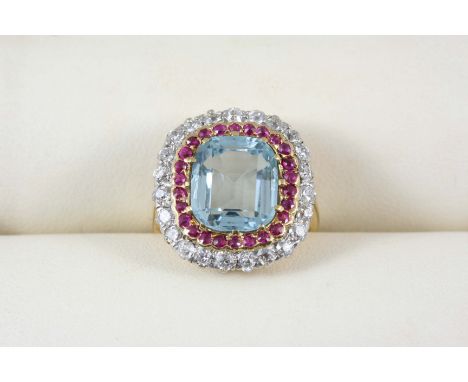 AN AQUAMARINE, RUBY AND DIAMOND CLUSTER RING the oval-shaped aquamarine weighs approximately 3.02 carats and is set within a 