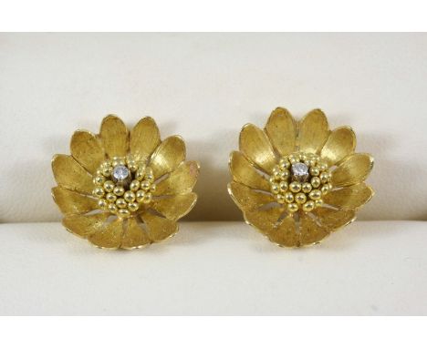 A PAIR OF GOLD AND DIAMOND EARRINGS each earring formed as a gold flowerhead and centred with a single-cut diamond, 2cm. dia.