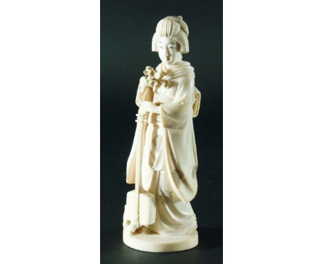 JAPANESE IVORY OKIMONO, Meiji, single piece, geisha holding a shamisen, carved fish scales to underside, 20cm