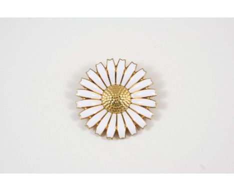 A WHITE ENAMEL AND SILVER GILT DAISY BROOCH BY GEORG JENSEN with maker's mark to the reverse, 4.5cm. dia.