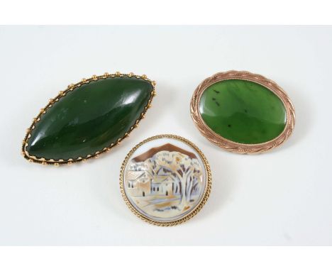 A JADE AND GOLD BROOCH the lozenge-shaped jade is set within a gold frame with ball decoration, 5cm. long, together with two 