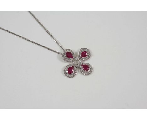 A RUBY AND DIAMOND PENDANT the quatrefoil pendant is set with four pear-shaped rubies within a surround of circular-cut diamo