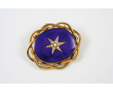 A VICTORIAN BLUE ENAMEL AND GOLD BROOCH the oval section of blue guilloche enamel is centre with a gold star set with half pe