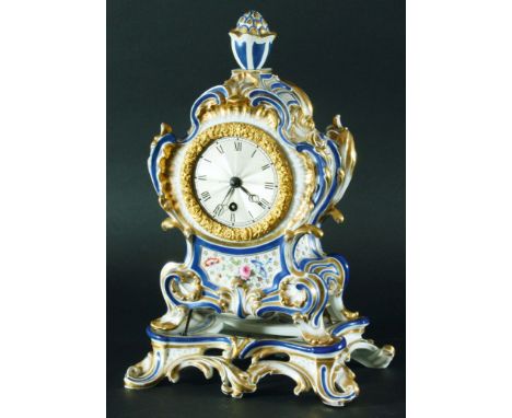 JACOB PETITE PORCELAIN MANTEL CLOCK, the 7cm engine turned dial in a scrolling case with floral panels, blue and gilt frames,