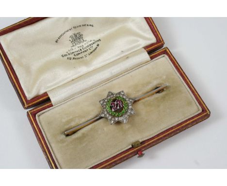A DIAMOND, RUBY AND ENAMEL REGIMENTAL BROOCH OF THE 22ND, THE CHESHIRE REGIMENT the ruby set 22 is set within a green enamel 