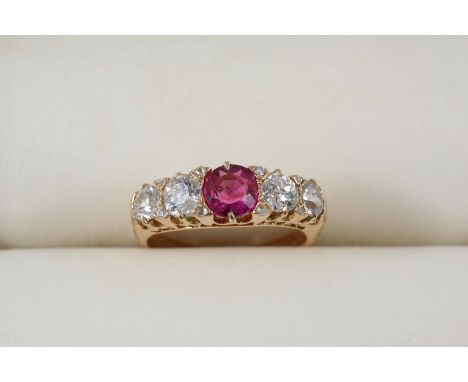 A RUBY AND DIAMOND RING the circular-cut ruby is set with four graduated old brilliant-cut diamonds, with rose-cut diamond hi