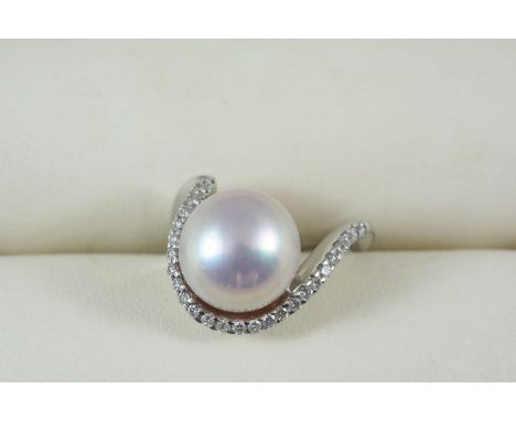 A CULTURED PEARL AND DIAMOND RING the slightly pink cultured pearl measures approximately 11.0mm., and is set within a half s