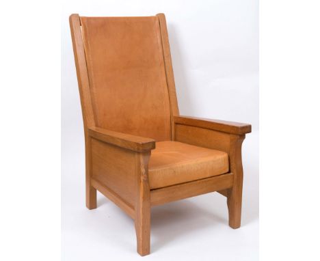 ROBERT THOMPSON OF KILBURN - MOUSEMAN SMOKING CHAIR an oak framed high back chair with a slung leather back and cushion seat.