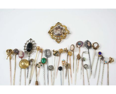 A QUANTITY OF ASSORTED STICK PINS together with a Victorian gold coloured metal mourning brooch, 4.5cm. wide.
