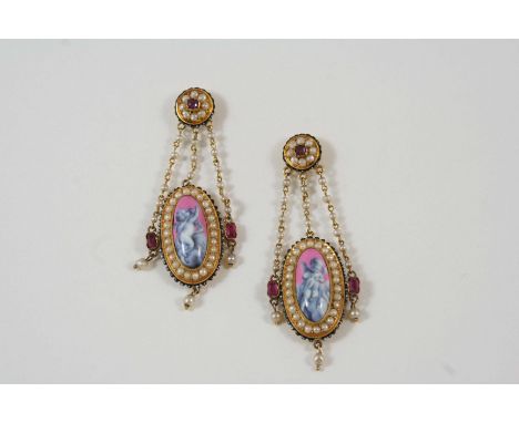 A PAIR OF VICTORIAN ENAMEL AND GEM SET DROP EARRINGS each set with an oval-shaped enamel plaque depicting a cherub within a s