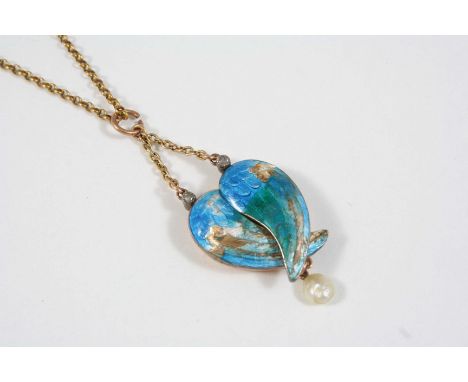 AN ENAMEL AND PEARL WINGED LOCKET BY CHILD & CHILD the turquoise enamel wings open to reveal a heart-shaped gold locket, susp