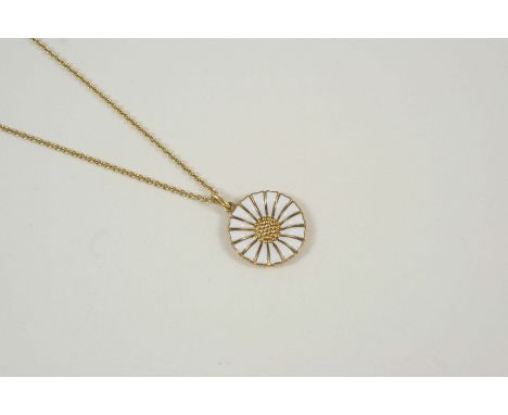 A WHITE ENAMEL AND SILVER GILT DAISY PENDANT BY GEORG JENSEN with maker's mark to the reverse, 2cm. dia., on a silver gilt ne