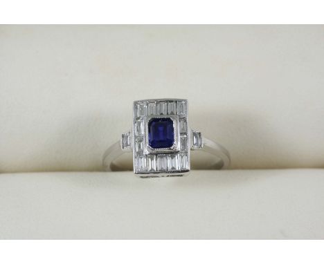 A SAPPHIRE AND DIAMOND CLUSTER RING the octagonal-shaped sapphire is set within a surround of baguette-cut diamonds, with a b