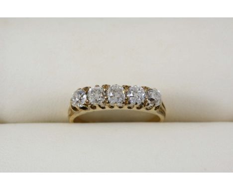 A DIAMOND FIVE STONE RING set with five cushion-shaped diamonds, in gold. Size P.