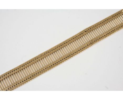 AN 18CT. GOLD BRACELET the central openwork panel with chevron design border, with concealed clasp, 19cm. long, 49 grams.
