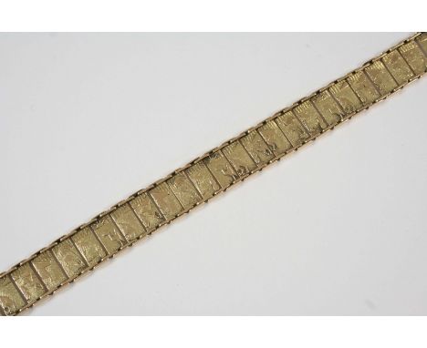 A 14CT. GOLD PANEL BRACELET engraved with Egyptian scenes, with concealed clasp, 20.5cm. long, 25 grams.