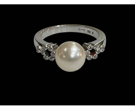 Mikimoto pearl and fourteen stone diamond, 18 carat white gold ring, size M.