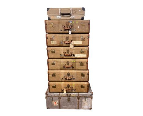 Vintage travelling trunk and seven vintage suitcases.