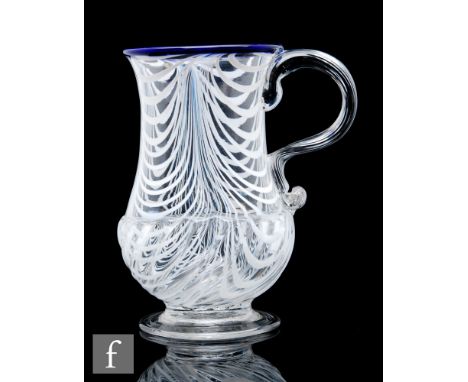 An 18th Century glass ale tankard, circa 1780-1800, of footed baluster form decorated with pulled opal threads, gadrooned bas