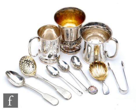 A small parcel lot of assorted hallmarked and other silver items to include three christening mugs, a caddy spoon and assorte