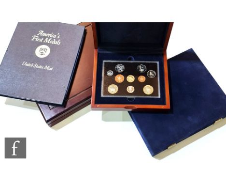 An Elizabeth II 2004 Executive proof coin collection in mahogany finish case with booklet, Westminster royal family coloured 