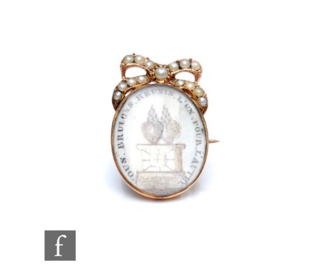 A 19th Century French gold memorial brooch with oval panel below a seed pearl set pediment, length 22mm, weight 2.1g, 'we bur