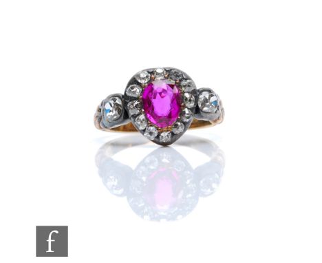 An early 19th Century ruby and diamond cluster ring, central oval ruby, length 6mm, within a border of cushioned old cut diam