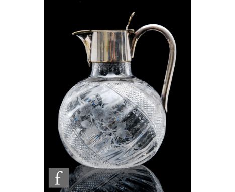 A Victorian glass jug of globe and shaft form, the body engraved with scrolling foliage between bands of fine cut diamonds, w