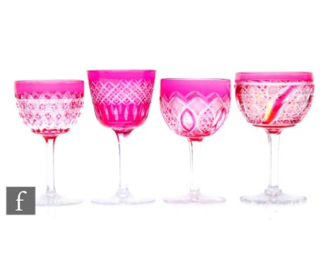 A mixed collection of four late 19th Century Stourbridge wine glasses, each cased in ruby over clear crystal with various ass