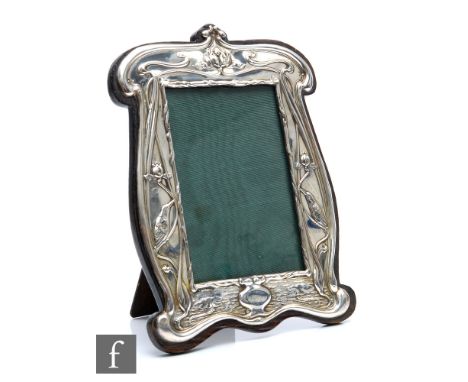 An Edward VII hallmarked silver photograph frame in the Art Nouveau style with kingfisher and water lilies amidst sinuous fol