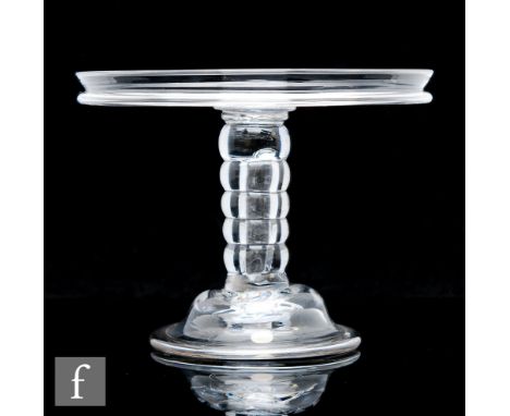 An 18th Century clear crystal glass tazza circa 1740, with a wide circular top and collar rim, above a six section hollow bob