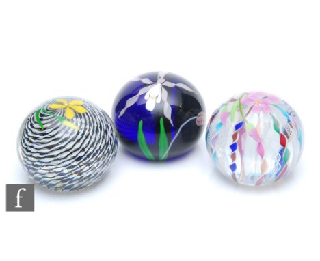 A Twists Glass paperweight designed by Mike Hunter, of domed form internally decorated with alternating latticino canes and m