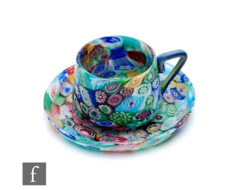 A late 19th Century Venetian Fratelli Toso glass cup and saucer formed of fused millefiori canes in green, blue, red, yellow 