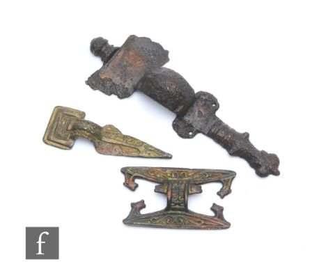 A Saxon iron cruciform brooch, side terminals missing, length 11cm, a similar belt buckle, a similar square back plate and ch