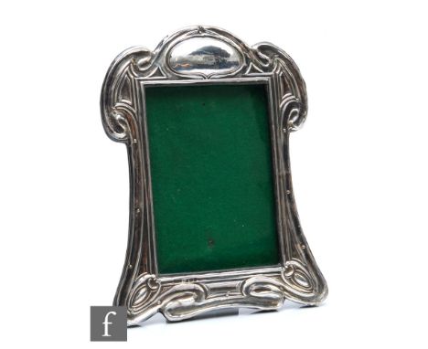 A George V hallmarked silver photograph frame in the Art Nouveau style with sinuous linear decoration, easel back, 19.5cm x 1