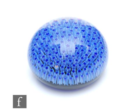 A later 20th Century Parabelle Glass paperweight, of domed form, internally decorated with a carpet of dark blue stars outlin