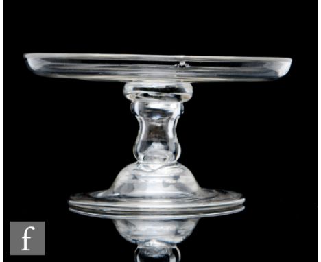 An 18th Century clear crystal patch stand, circa 1750, with a circular top and everted rim above a hollow blown waisted stem 