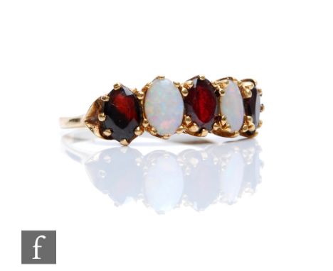 A 9ct hallmarked opal and garnet five stone ring, three garnets spaced by opals,&nbsp;weight 2.6g, ring size N. 