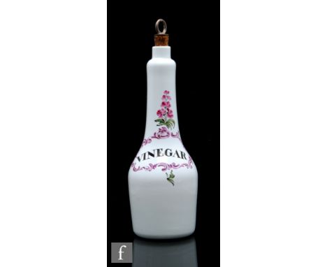 An 18th Century opaque glass vinegar bottle circa 1760, possibly South Staffordshire, enamel decorated with an oval cartouche
